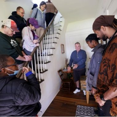 James Holly, Jr. with University of Michigan faculty, staff, students, and local community members visiting the Starkweather Homestead, located in Ypsilanti, MI, a stop on the Underground Railroad. James organized this trip as a co-lead of The Sankofa Project.