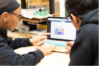 Students looking at a laptop